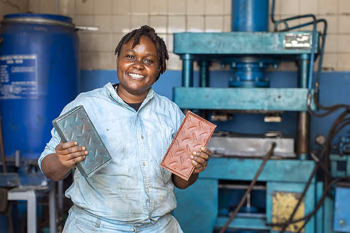 woman with bricks made of plastic waste