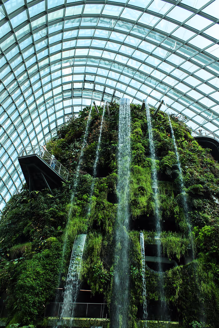 tall indoor waterfall with glass dome over top