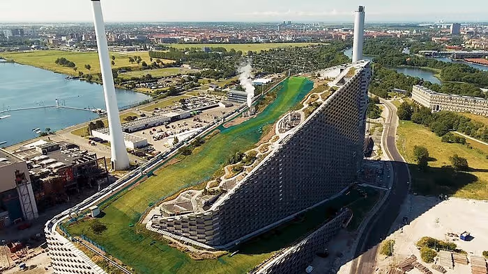 Large power plant building covered in sloping green park