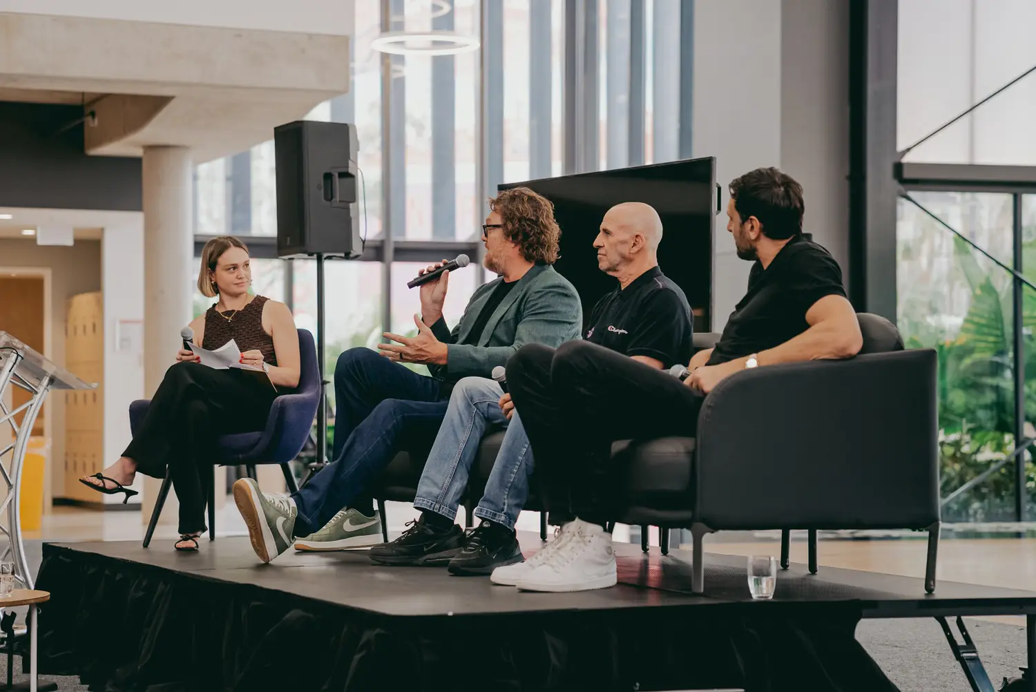 Luc Longley, Andrew Bogut and Brian Goorjian on stage with moderator Zoe Samios at the 2024 Kings Day Panel