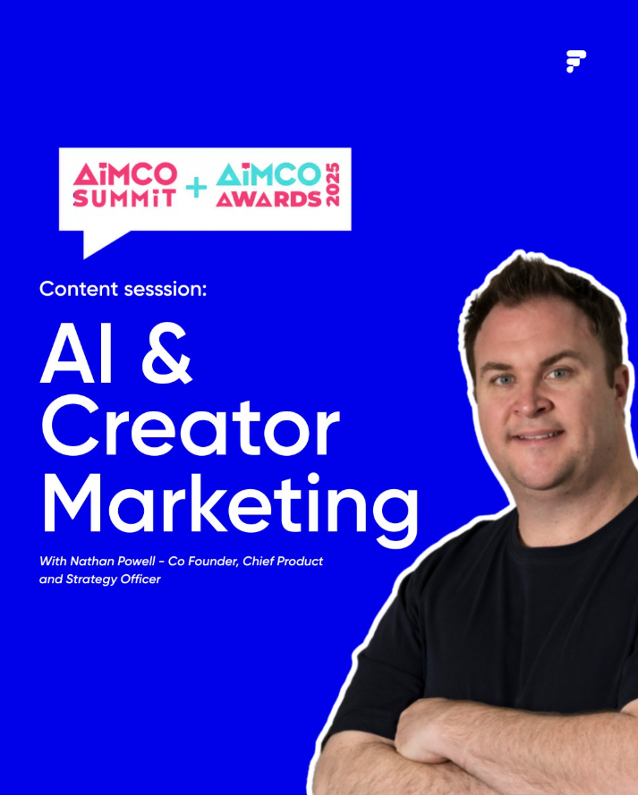 Two young women smiling and taking a selfie together against a purple background, one with pink hair and yellow flower decorations on her face, the other with curly hair and wearing a yellow top.