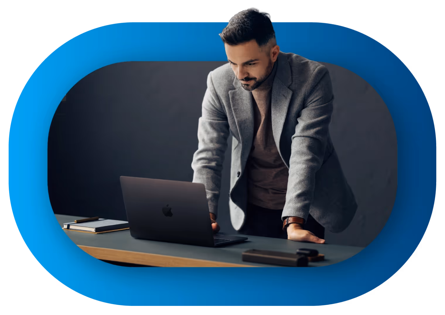 A man looks at an Apple laptop