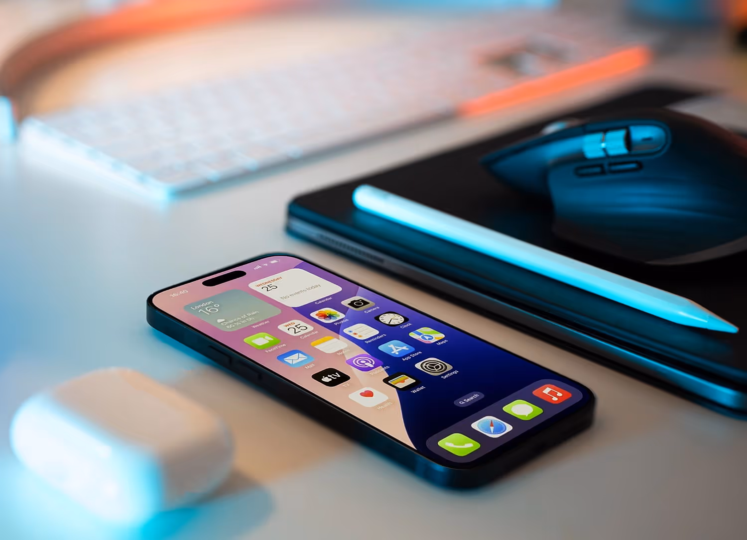iPhone on a desk with a pad next to it