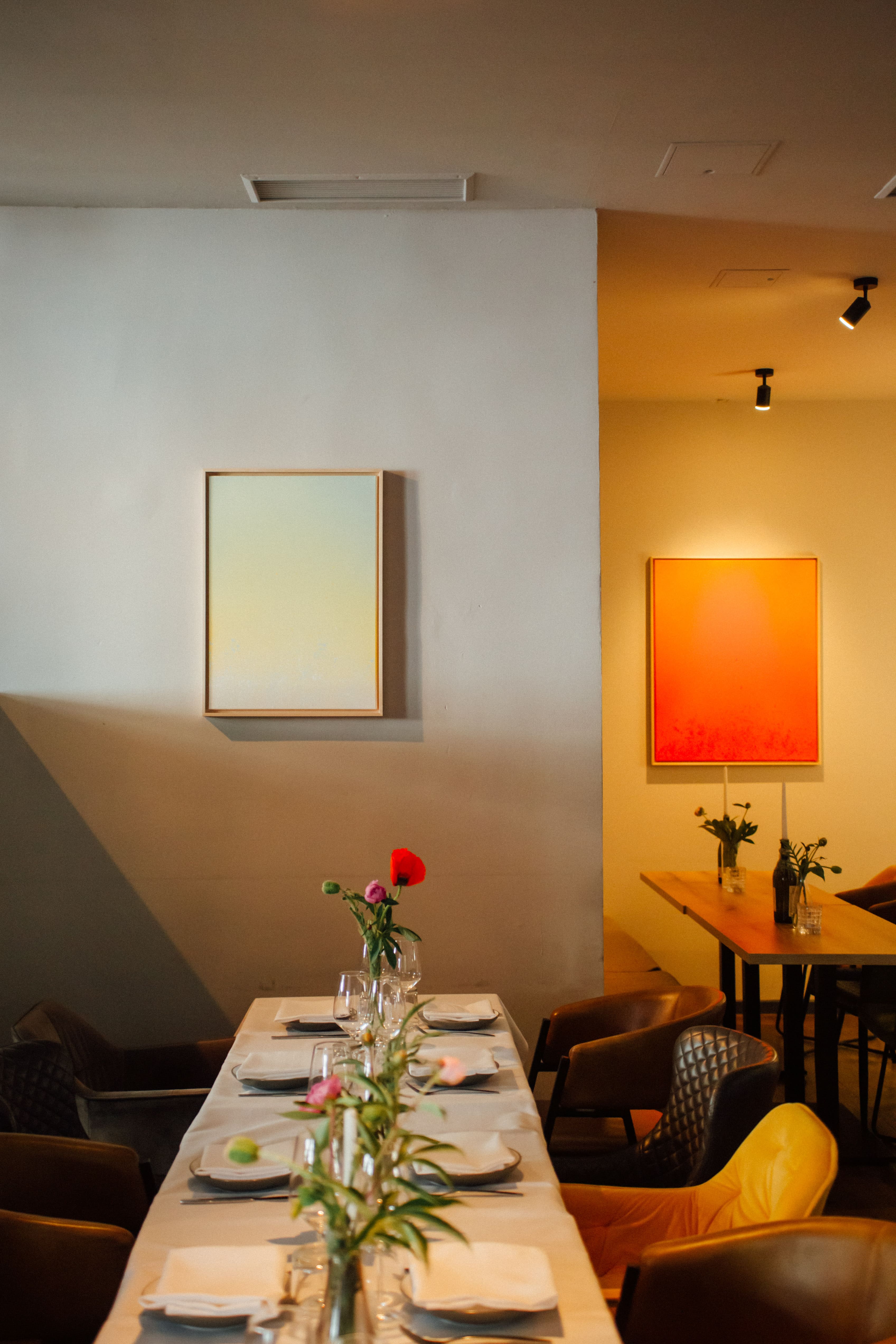 Das Restaurant mit gedeckten Tischen und Bildern an der Wand