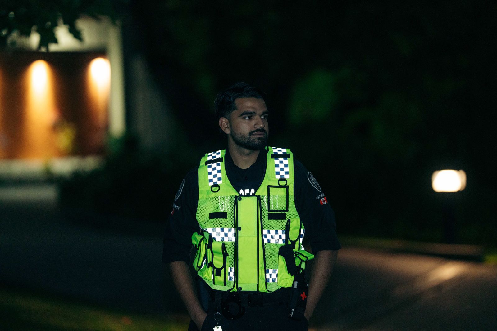 Grit Security officer wearing a reflective patrol vest during an after-hours exterior security check