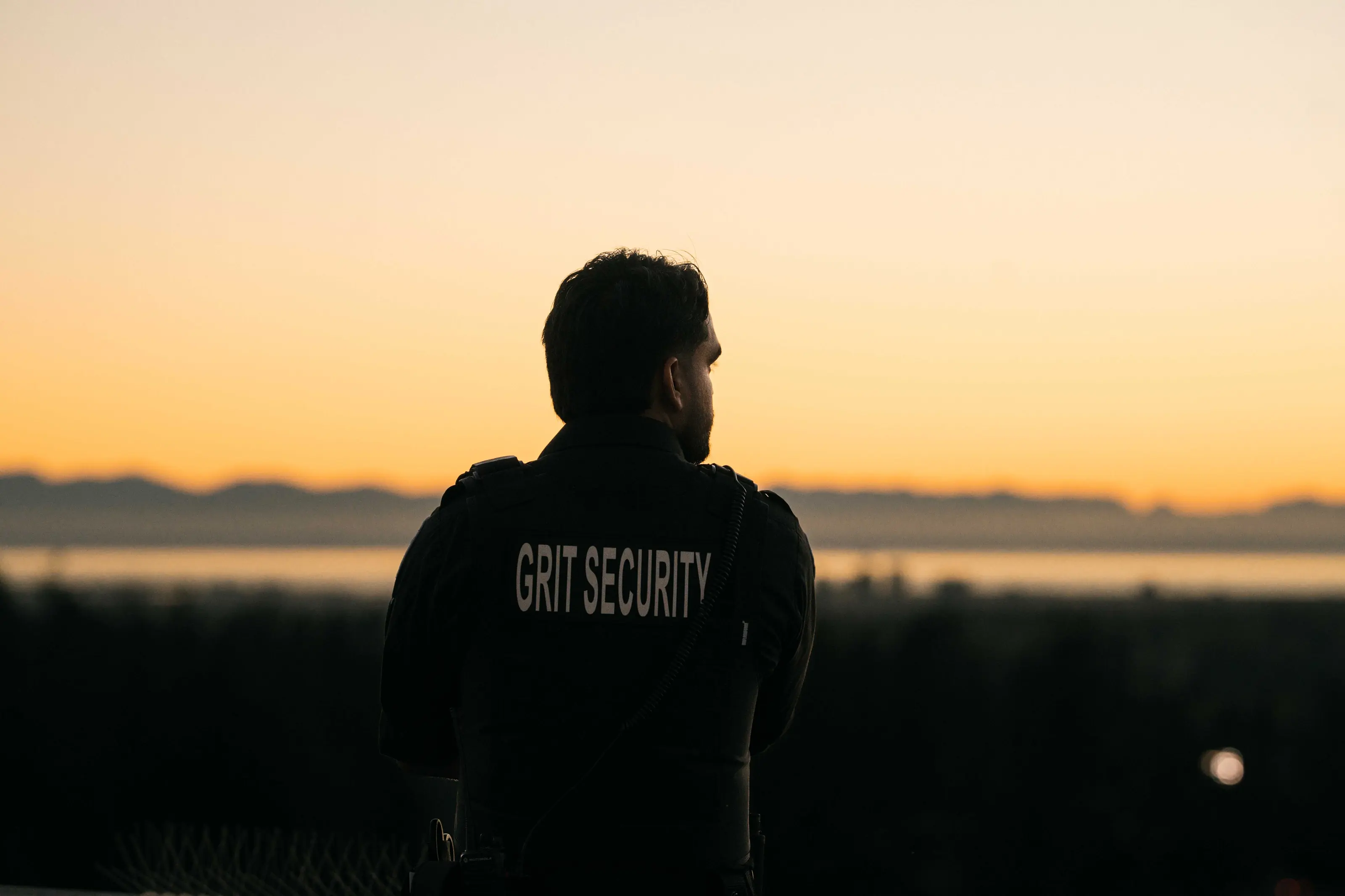 Grit Security officer overlooking a property at sunset.