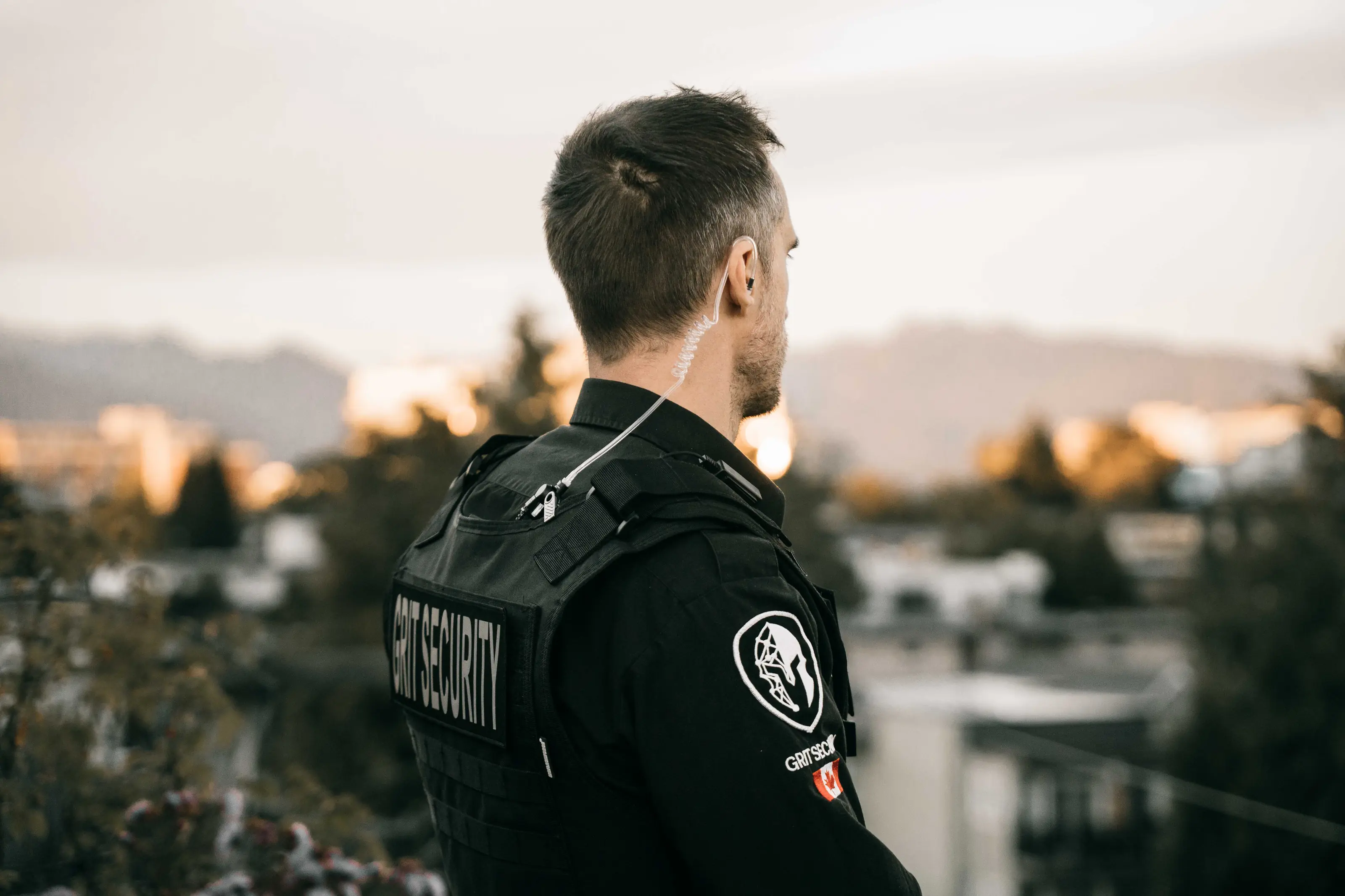 Grit Security officer overlooking an urban property at sunset.