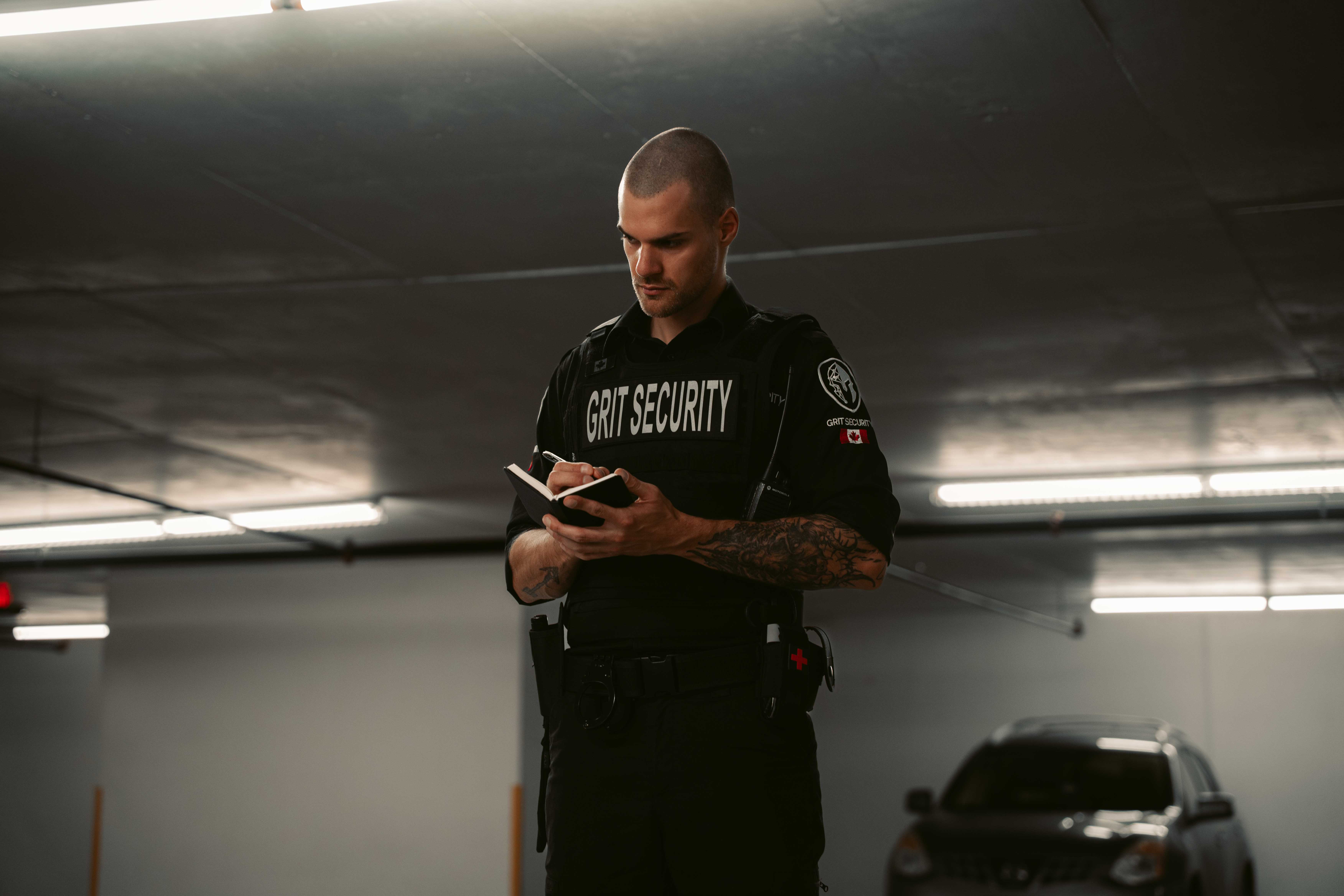 Grit Security officer documenting observations during a property patrol.