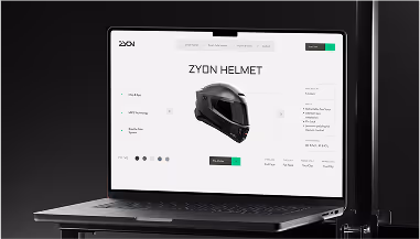 Laptop displaying an e-commerce page for a black Zyon motorcycle helmet with product details and purchase options.