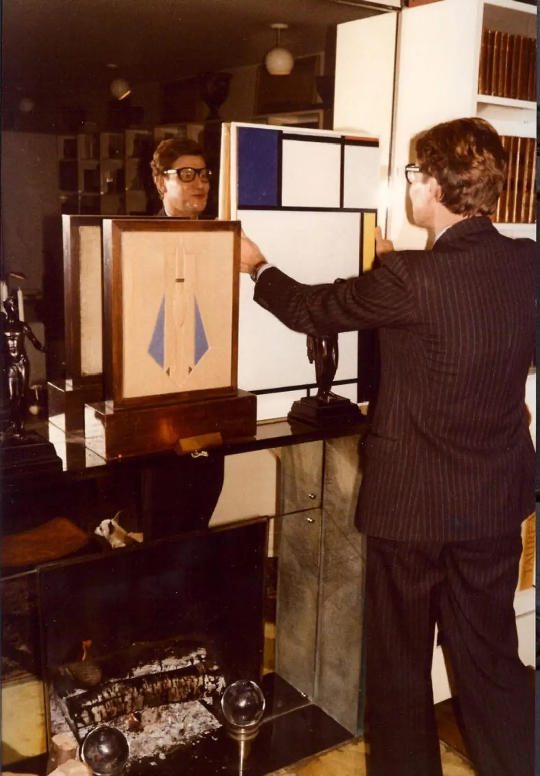 Yves Saint Laurent and Composition with blue, red, yellow, and black (1922) by Piet Mondrian in 55 rue de Babylon, Paris, 1980s