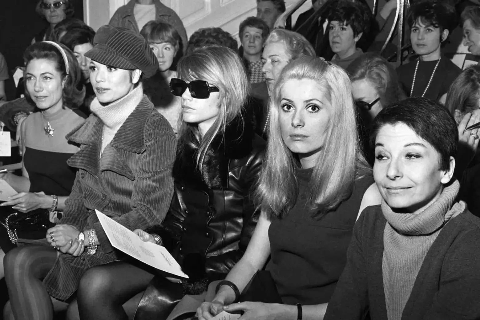 Elsa Martinelli, Françoise Hardy, Catherine Deneuve and Zizi Jeanmaire in the front row at Yves Saint Laurent Spring/Summer 1967 Elsa Martinelli, Françoise Hardy, Catherine Deneuve and Zizi Jeanmaire in the front row at Yves Saint Laurent Spring/Summer 1967
