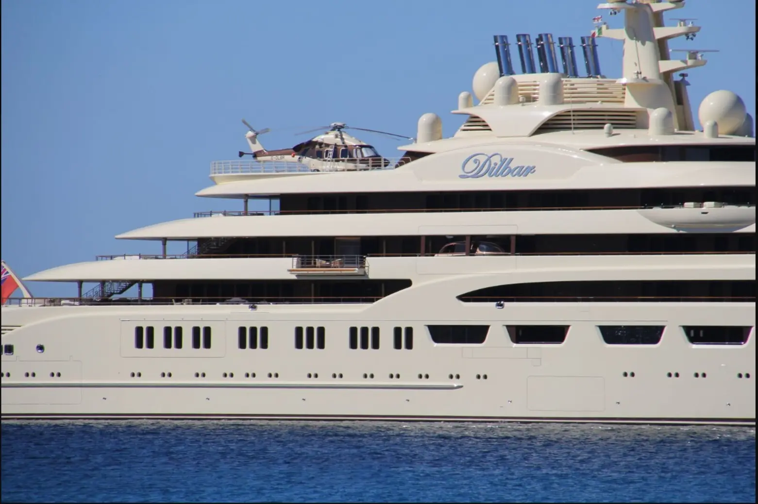 Dilbar yacht majestically cruising, a symbol of modern luxury.