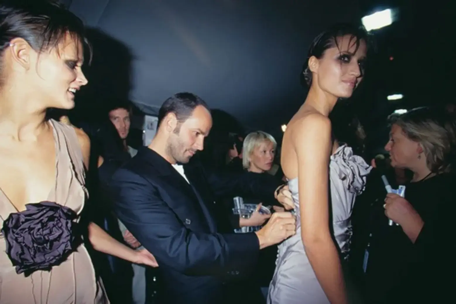 This image/scene captures Tom Ford backstage while he was making final preparations for the Spring 2003 Ready-to-Wear fashion show