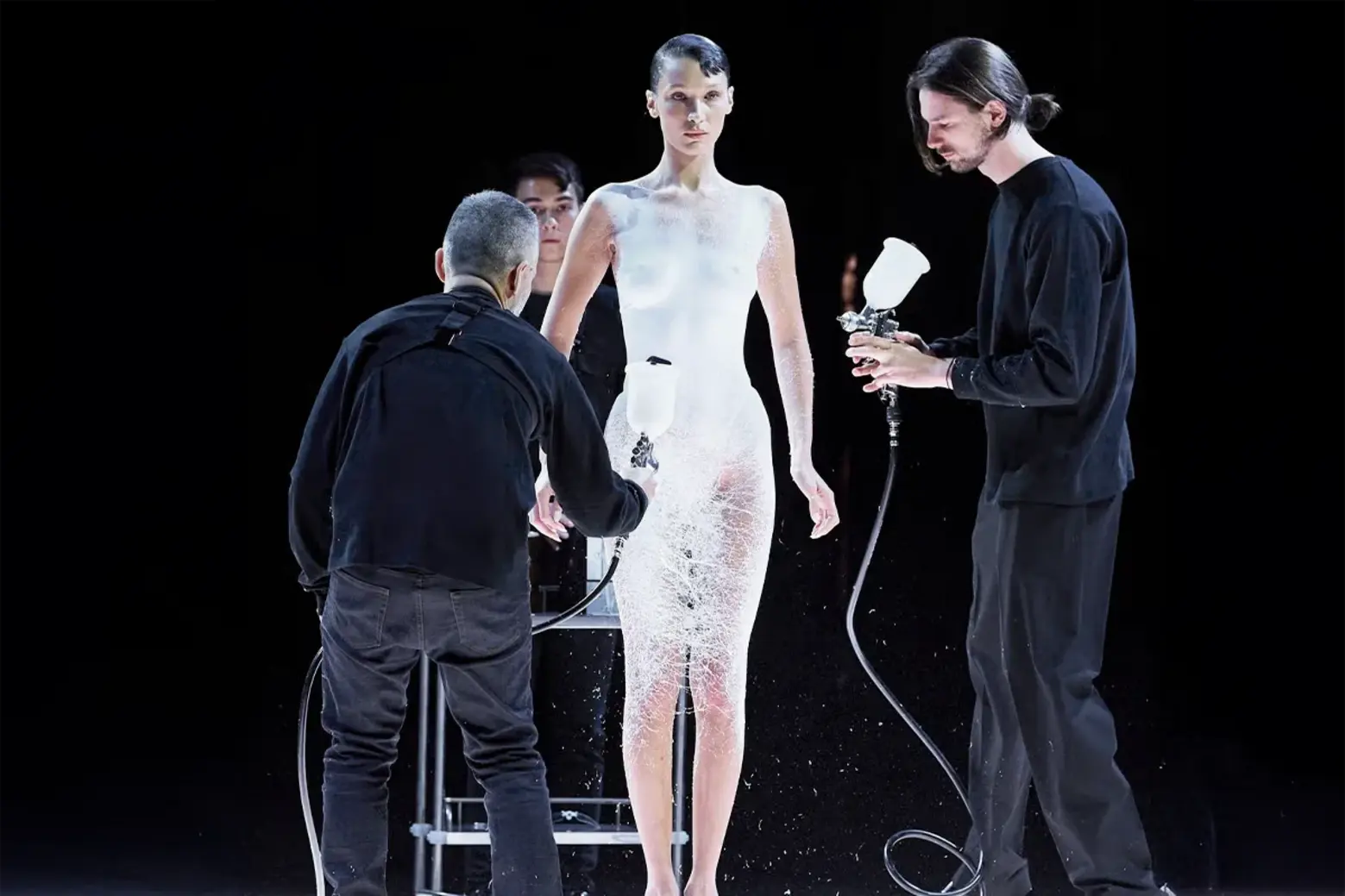 Coperni spraying Bella Hadid with liquid fabric in a viral performance art fashion moment