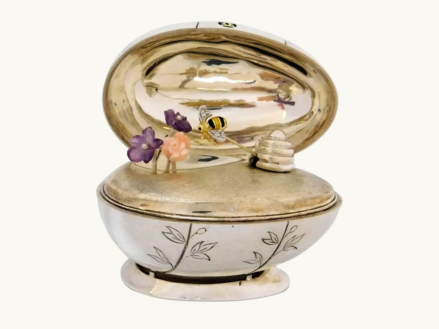 Limited-edition 1977 Cartier egg in sterling silver and 18-karat gold with a diamond and enamel bee