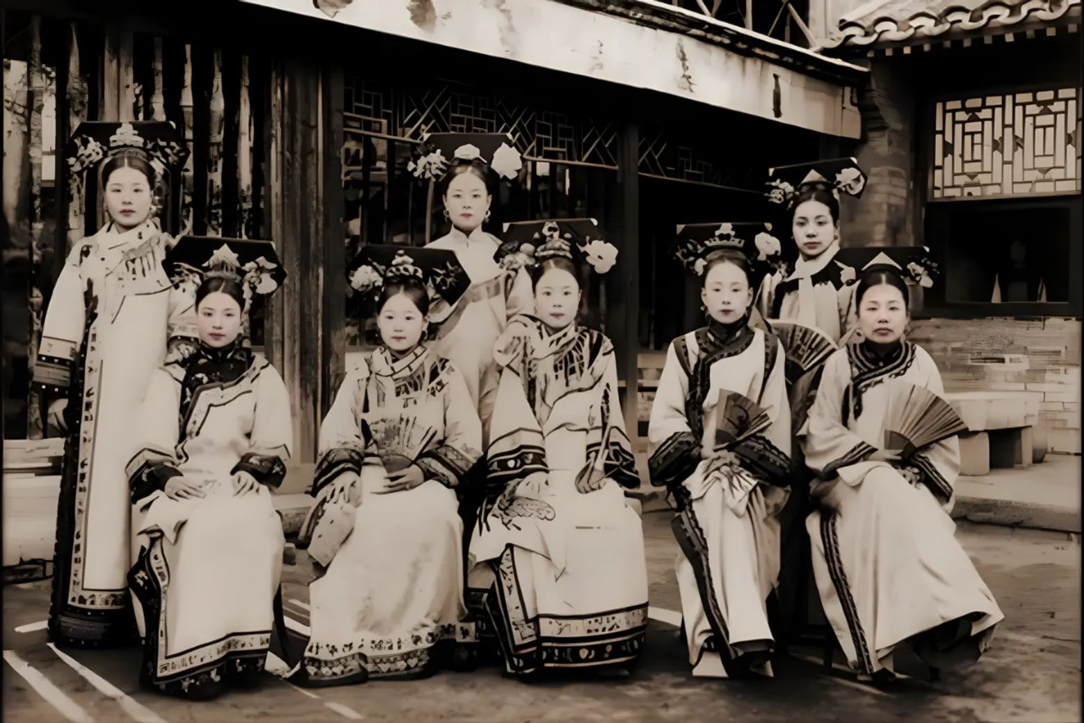 Court ladies in traditional Manchu robes Qipao a