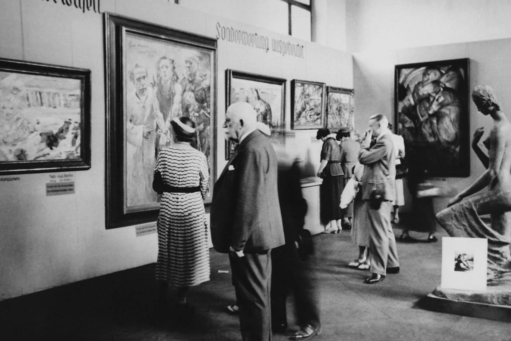 Visitors look at works in the Degenerate Art exhibition in Munich, Expressionism
