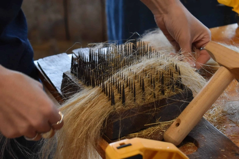 A flax hackle (or heckling comb), which is a traditional tool with sharp metal spikes used to comb and straighten plant fibers A flax hackle (or heckling comb), which is a traditional tool with sharp metal spikes used to comb and straighten plant fibers