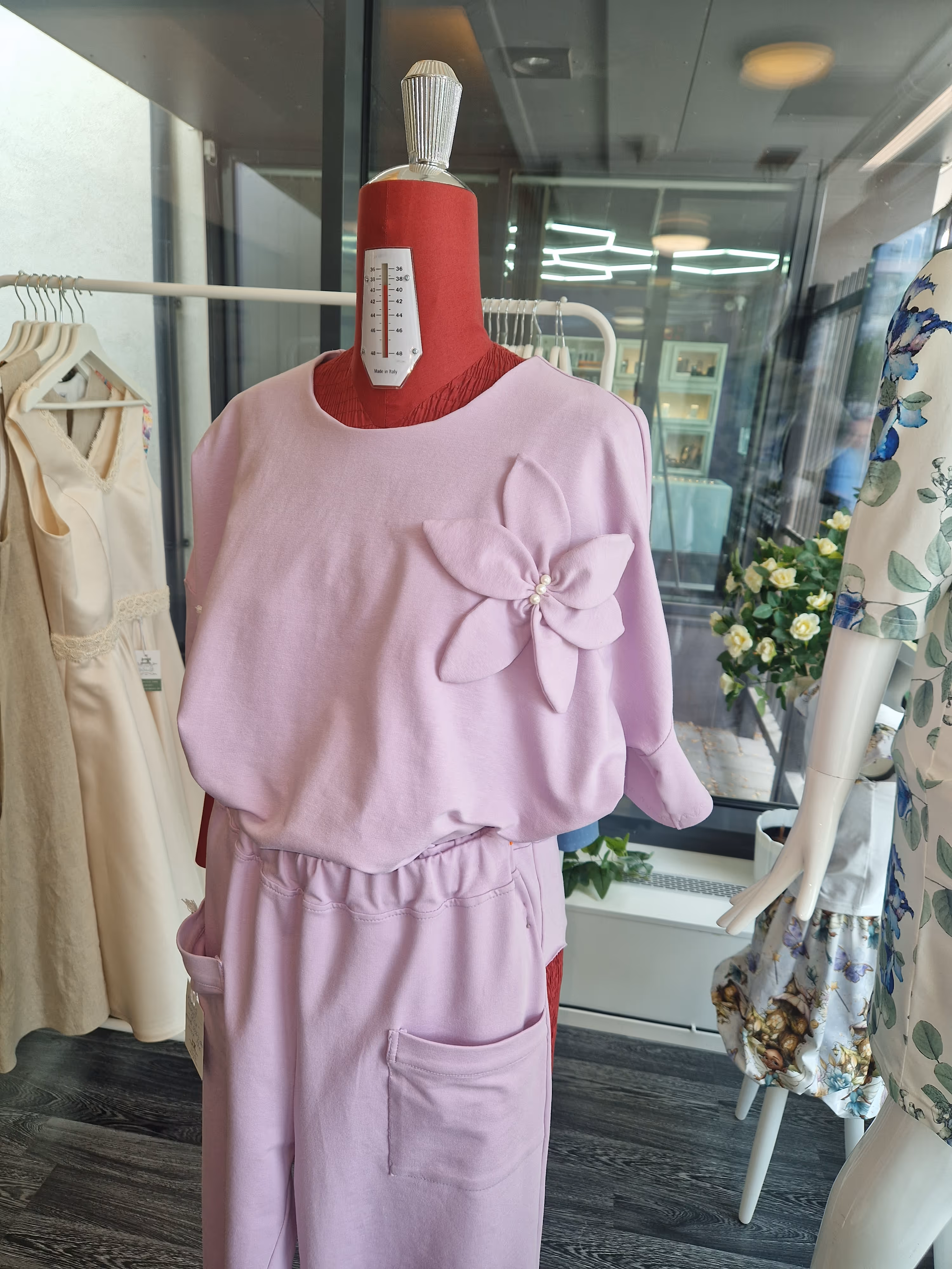 image of a customer being fitted with sewing pins in a tailor shop