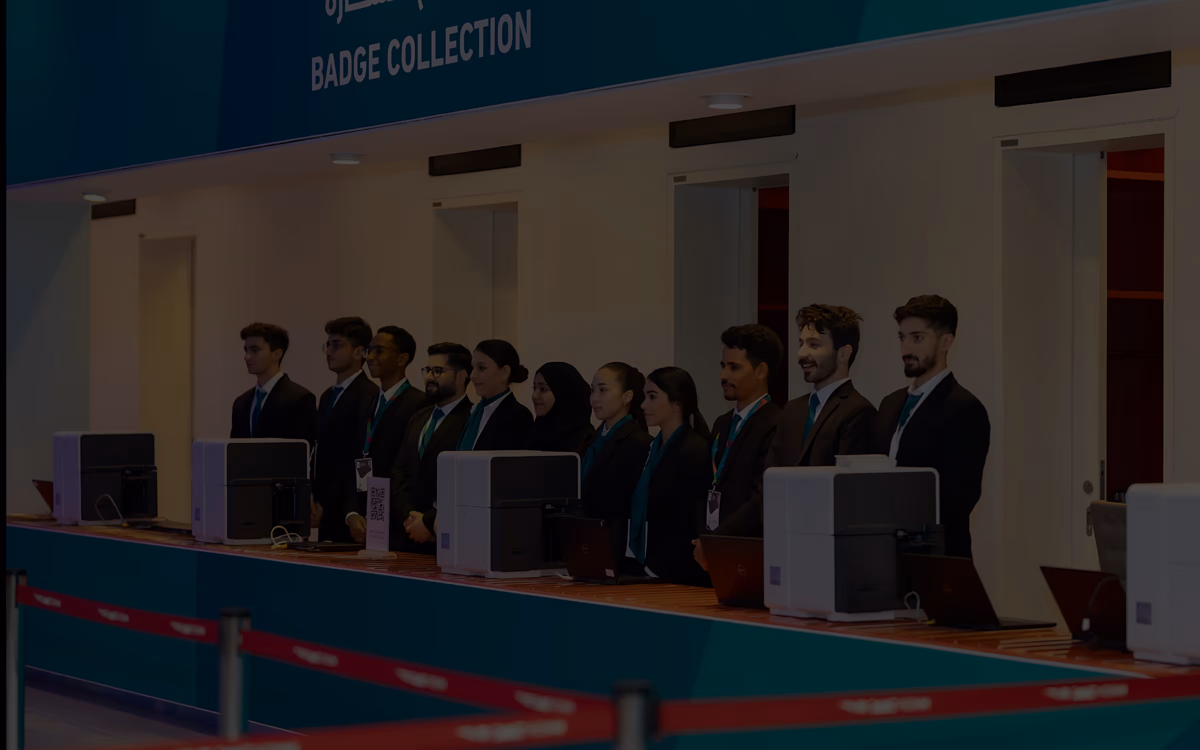 Professional conference setting with attendees at badge collection area