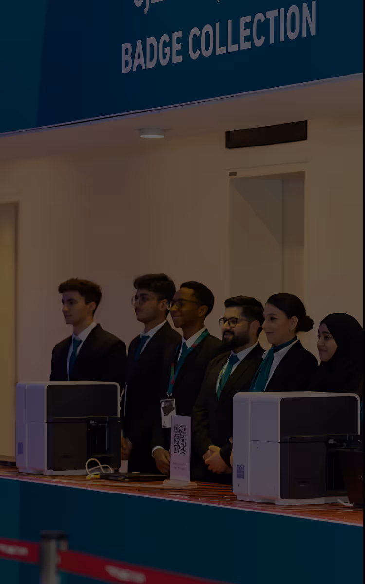 Professional conference setting with attendees at badge collection area