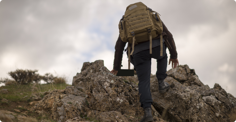 man doing mountain hiking and climbing in autumn