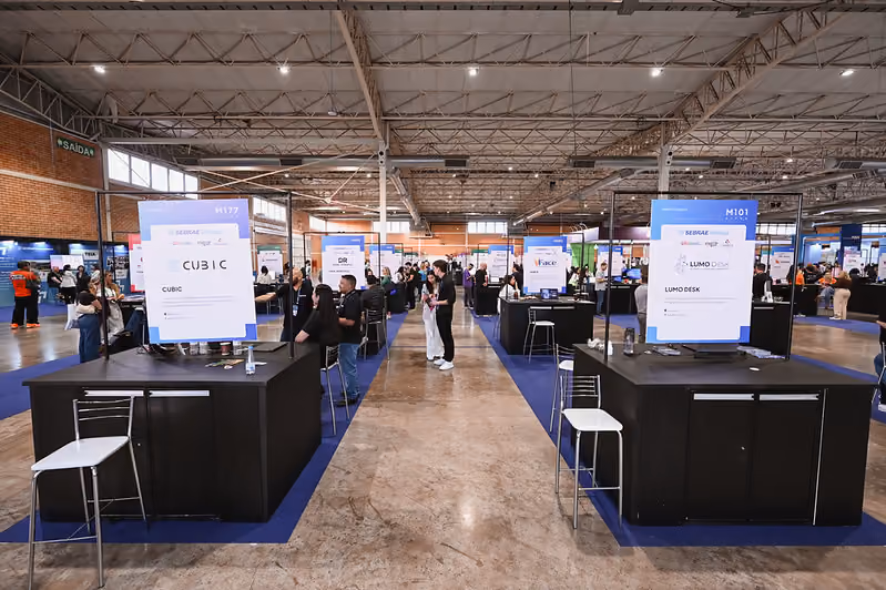 Corredor de estandes de startups na feira da Gramado Summit