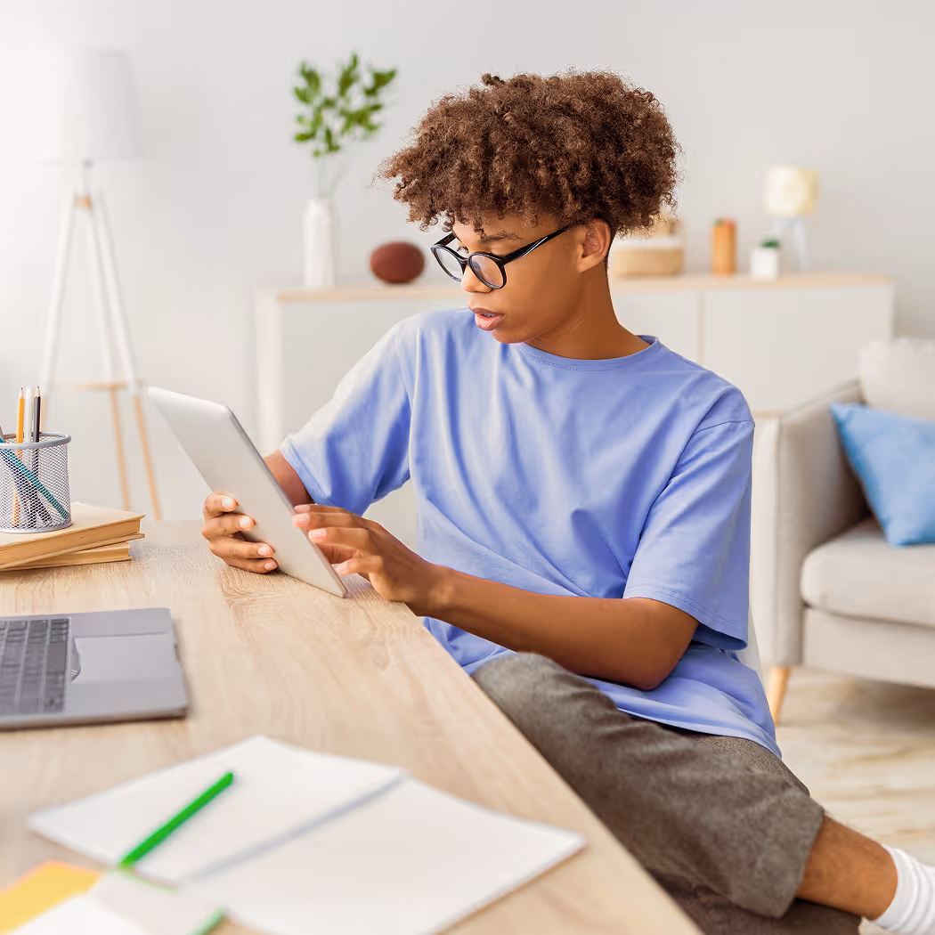 Teen using AI-powered micro-learning for children on tablet.