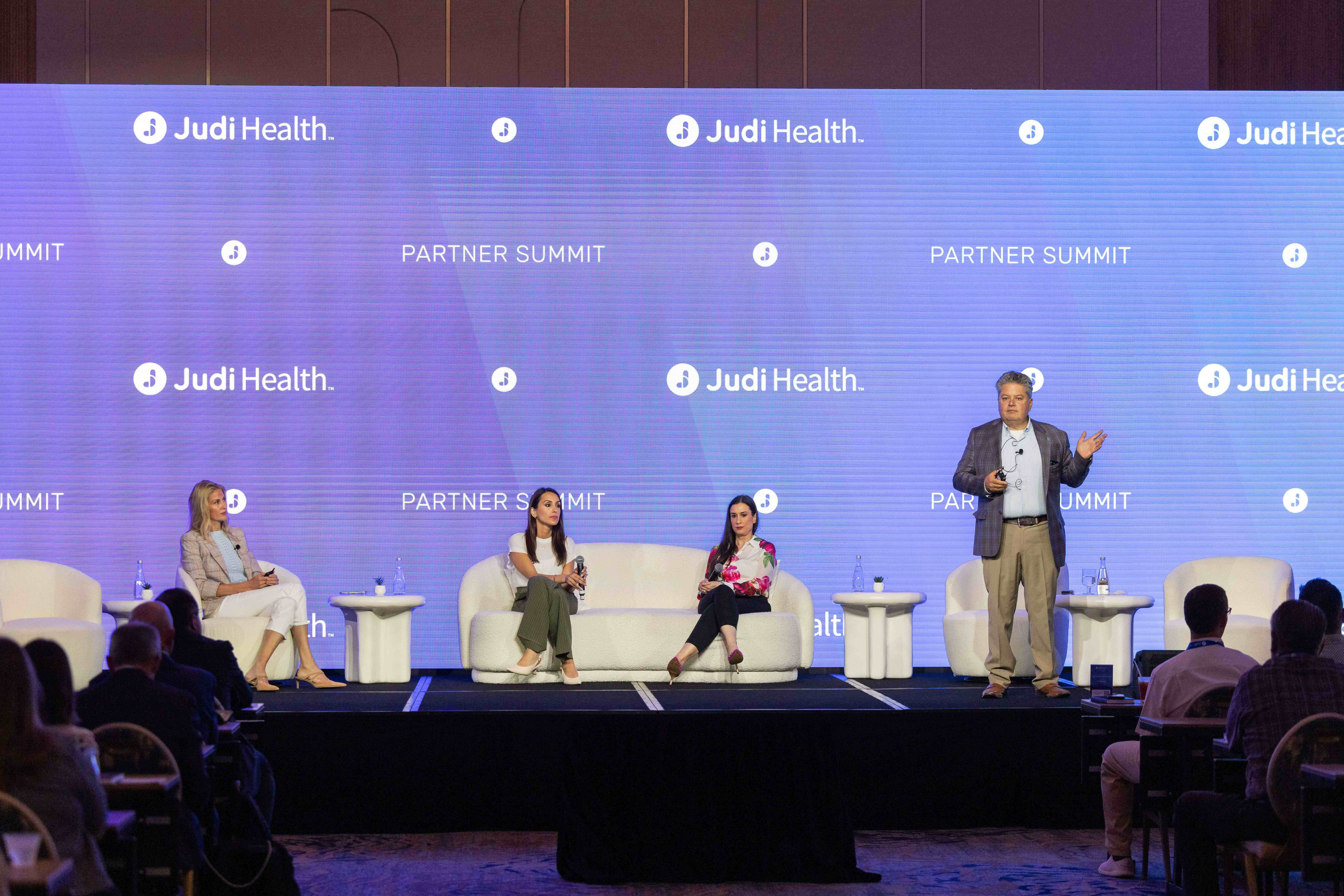 A panel discussion at Judi Health's Partner Summit with four speakers on stage.
