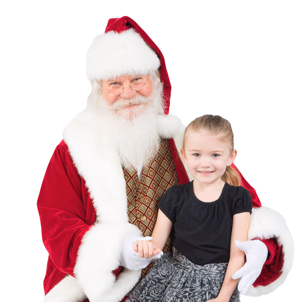 Smiling girl sitting on Santa Claus's lap holding his hand.