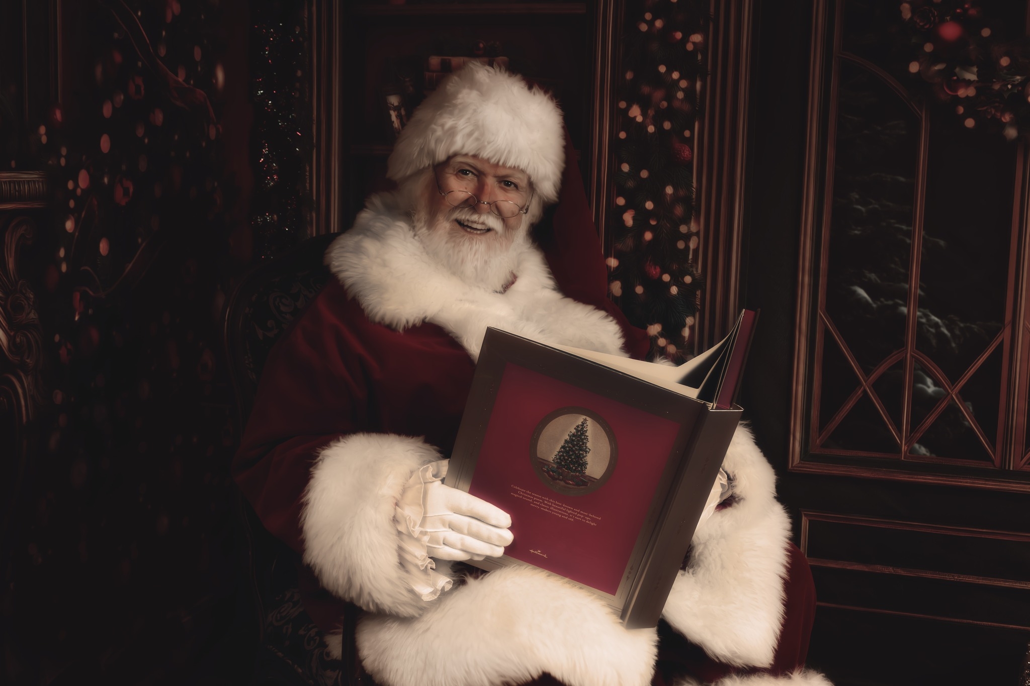 Close-up of Santa Claus wearing glasses and a red hat, smiling with a snowy white beard.