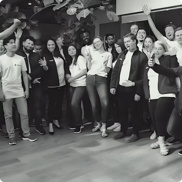 A large group of people poses happily for the camera