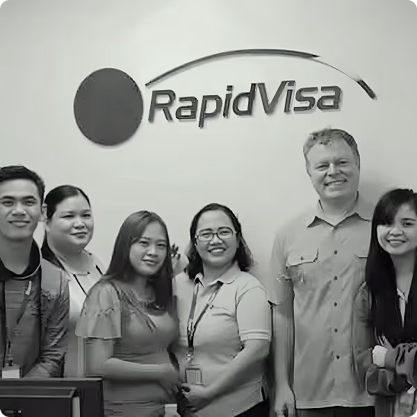 A group of people looks happily at the camera