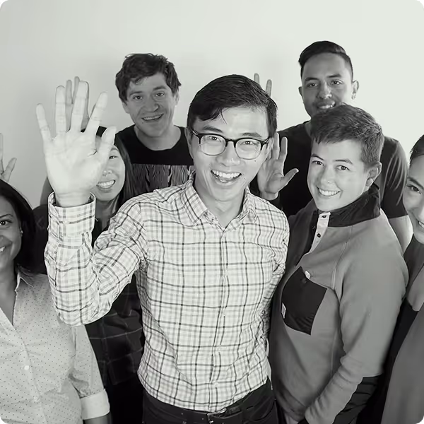 A picture of a group of people looking happily at the camera