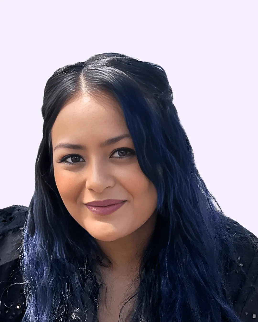 Woman with long dark hair wearing large glasses, a black jacket, pearl necklace, and decorative earrings, smiling and touching her glasses.