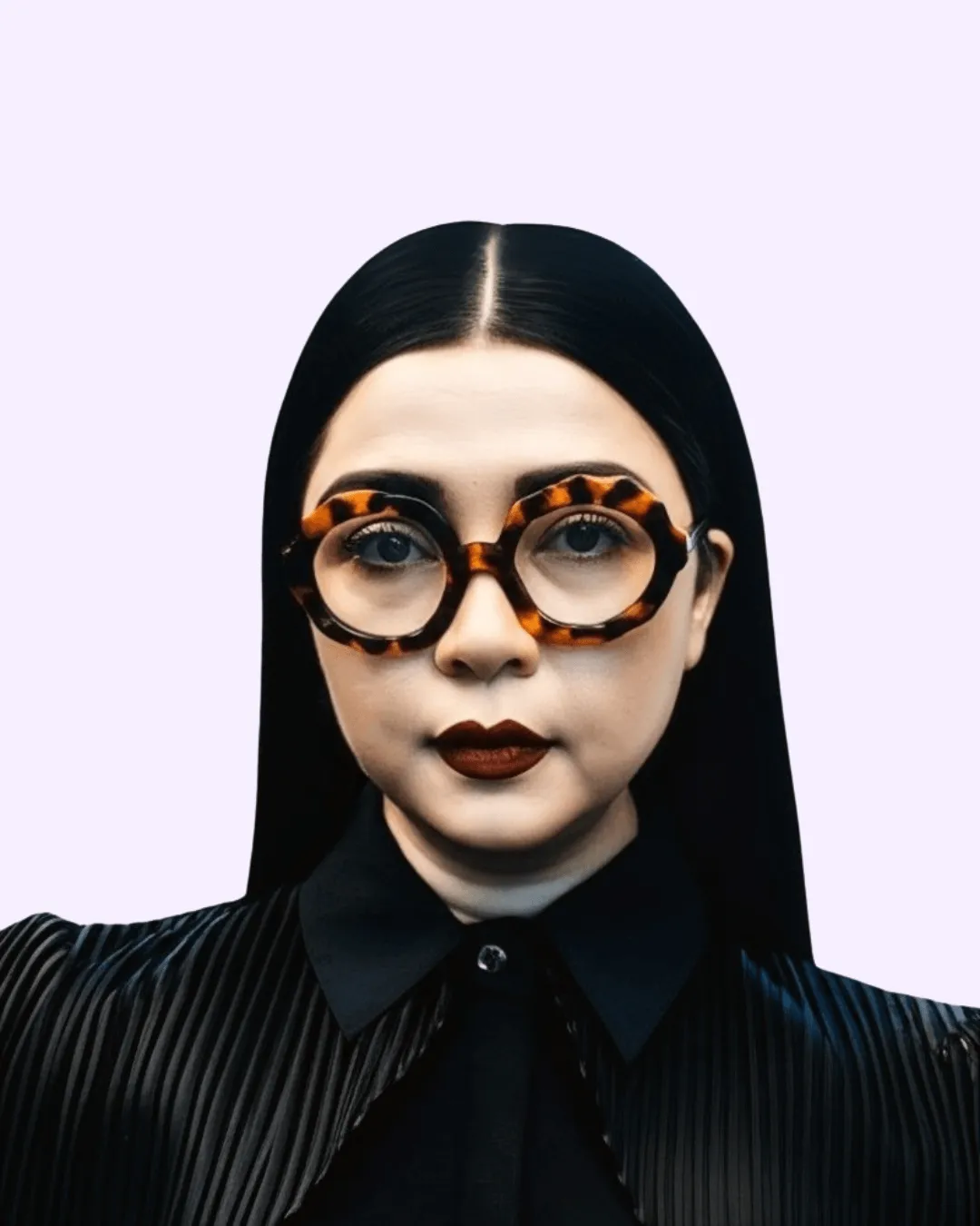 Woman standing on sidewalk wearing a dark blue denim dress with front buttons and black ankle boots.