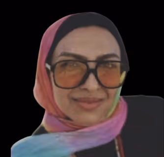 Woman with long dark hair wearing large glasses, a black jacket, pearl necklace, and decorative earrings, smiling and touching her glasses.