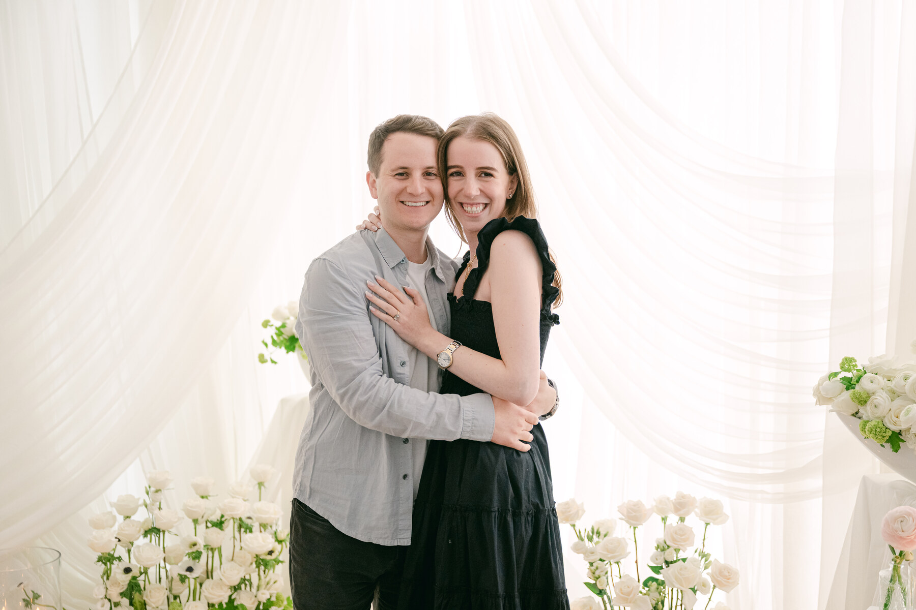 Jamie (bride) and Jordan (groom) smiling together from engagement