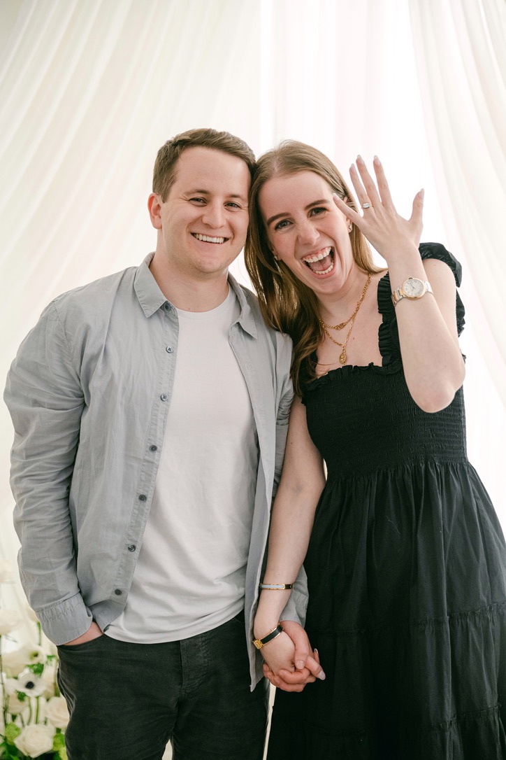 Happy couple smiling showing engagement