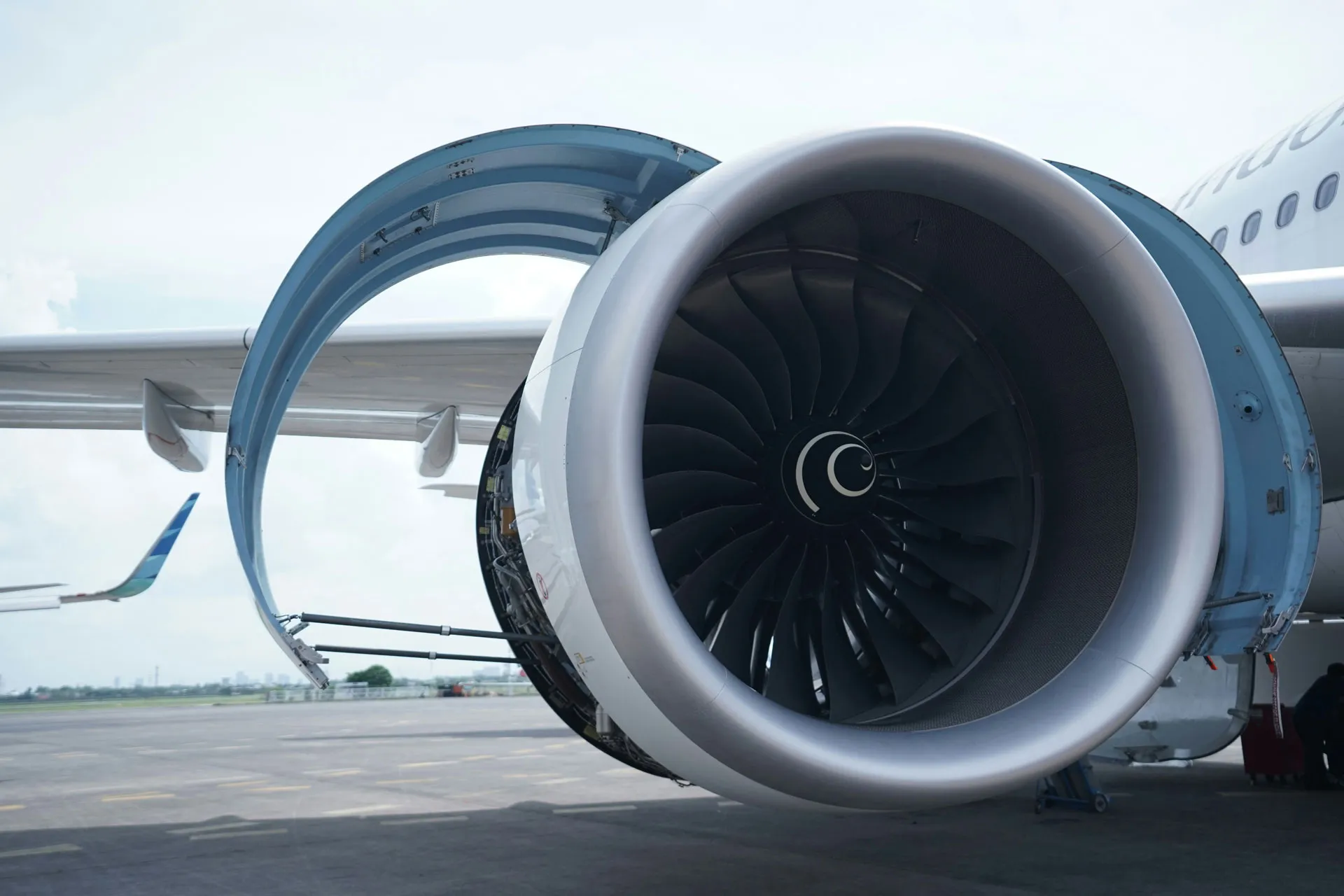 Photo of an airplane engine attached to a plane