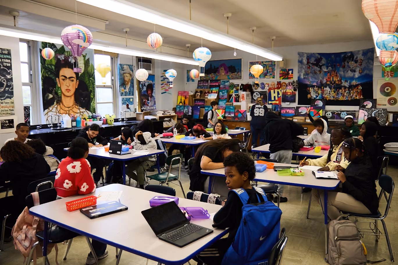 Students working at desks in a colorful art classroom