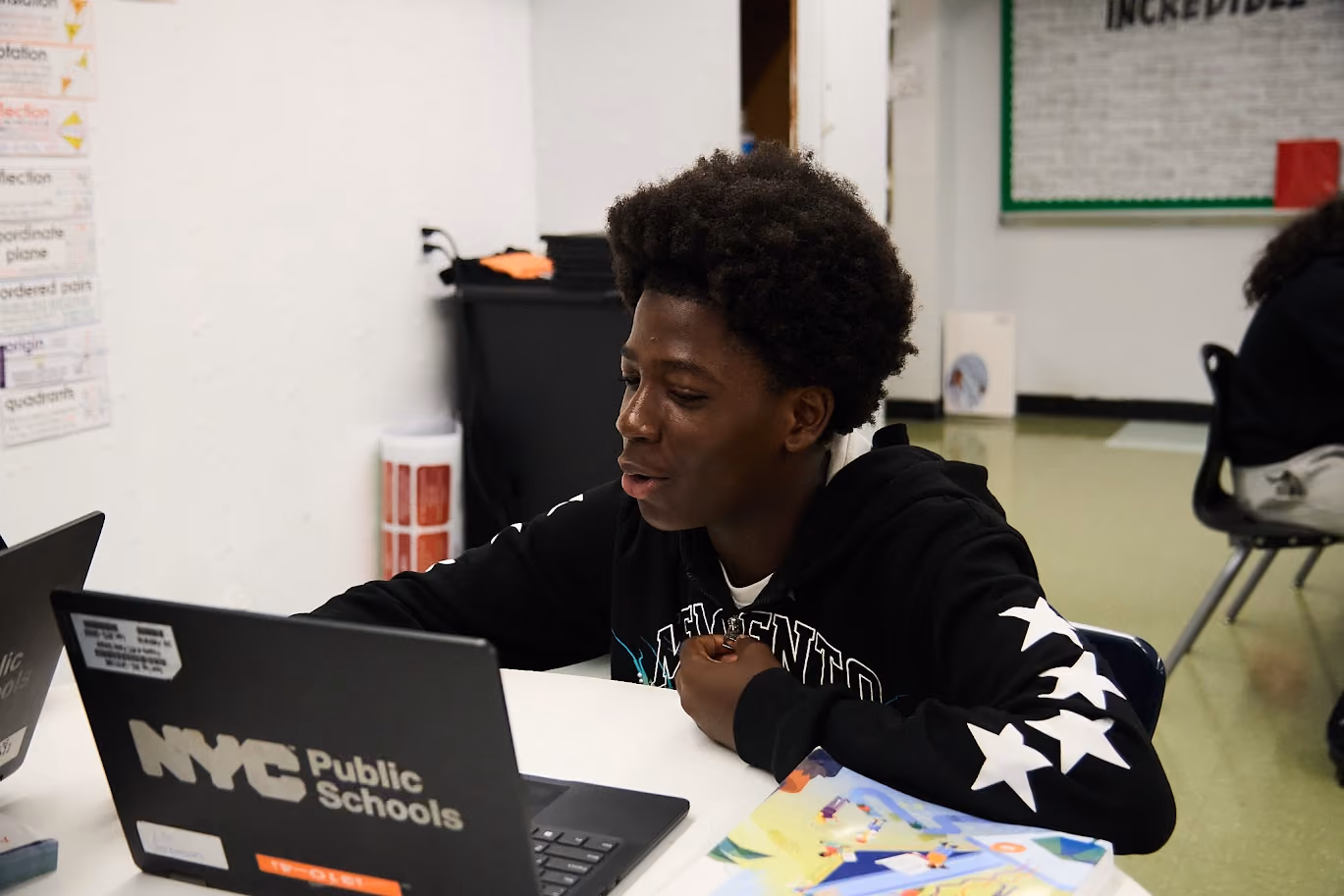 Student working on an NYC Public Schools laptop in class