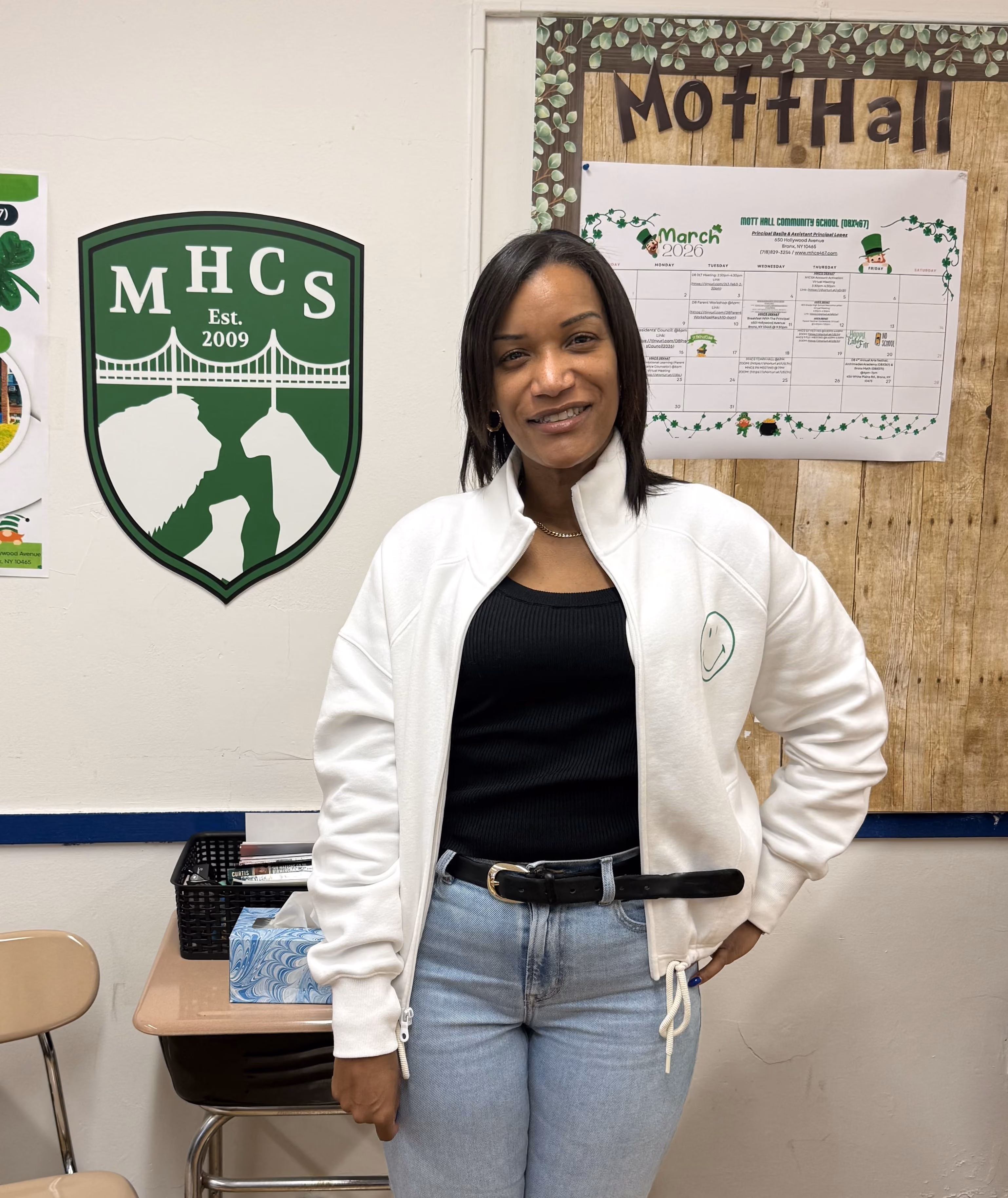 Staff member smiling in Mott Hall Community School classroom