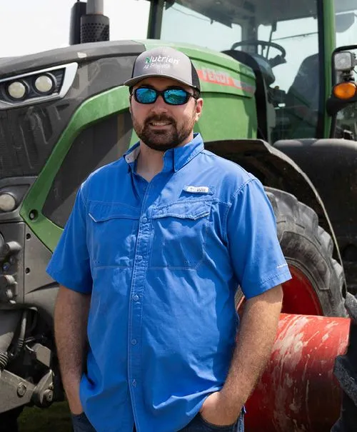 Lawson standing in front of a tractor.