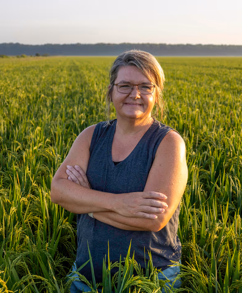 Jennifer standing in a rice field.
