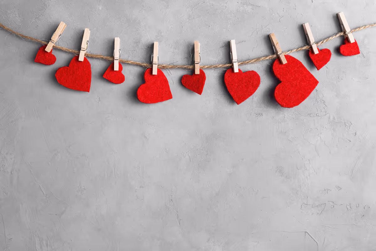 Felt Valentine hearts hanging on a rope with clothes pins