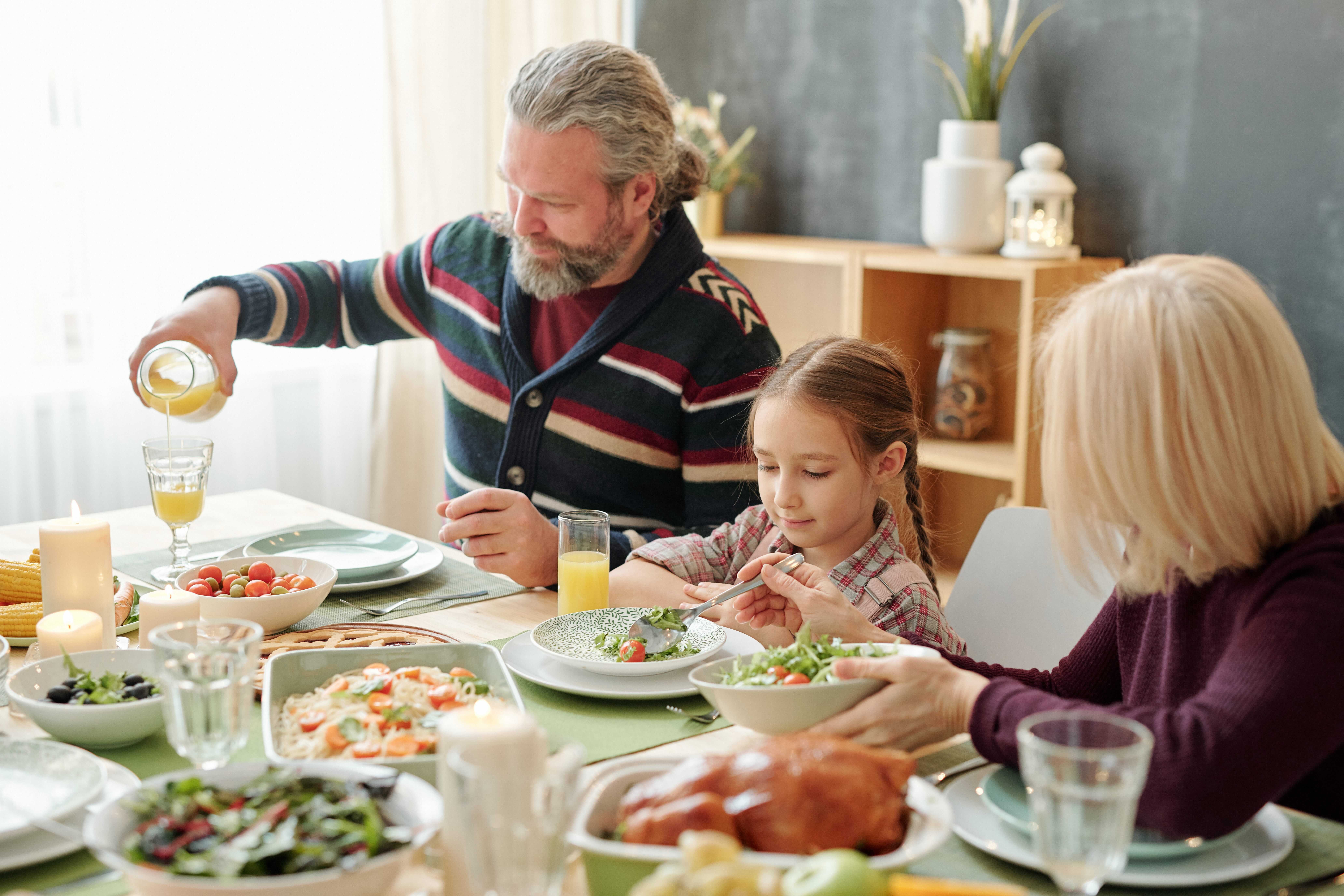 Child eating a meal with grandparents