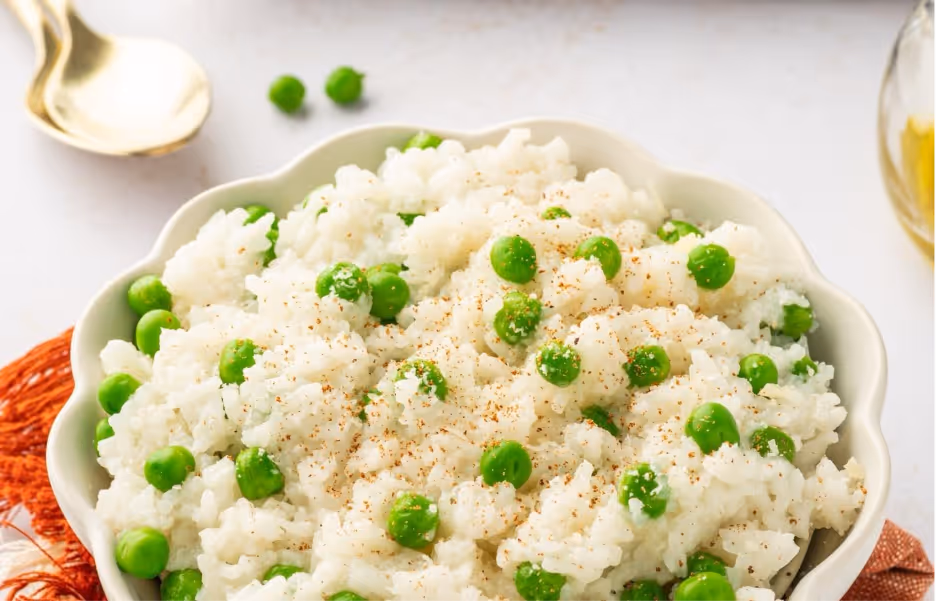 A bowl of rice and peasAI-generated content may be incorrect.