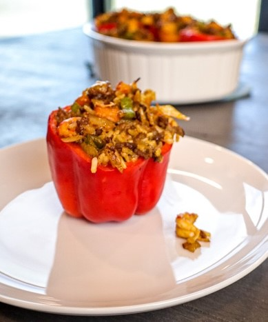 A red bell pepper stuffed with rice and vegetablesAI-generated content may be incorrect., Picture