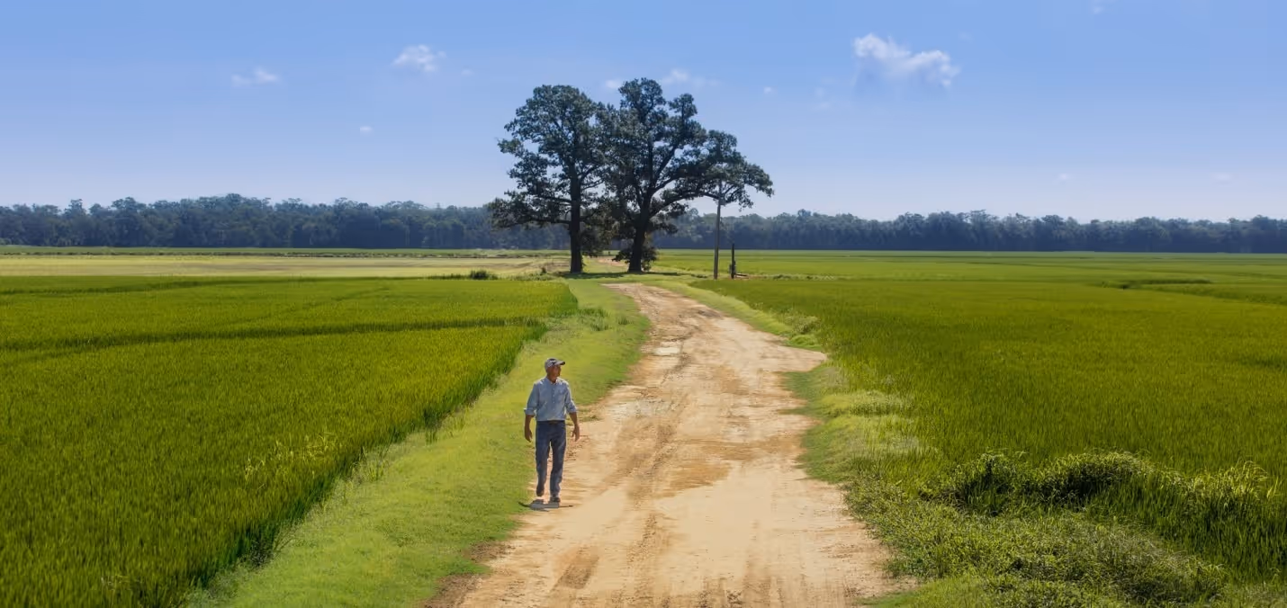 A person walking on a dirt roadAI-generated content may be incorrect., Picture